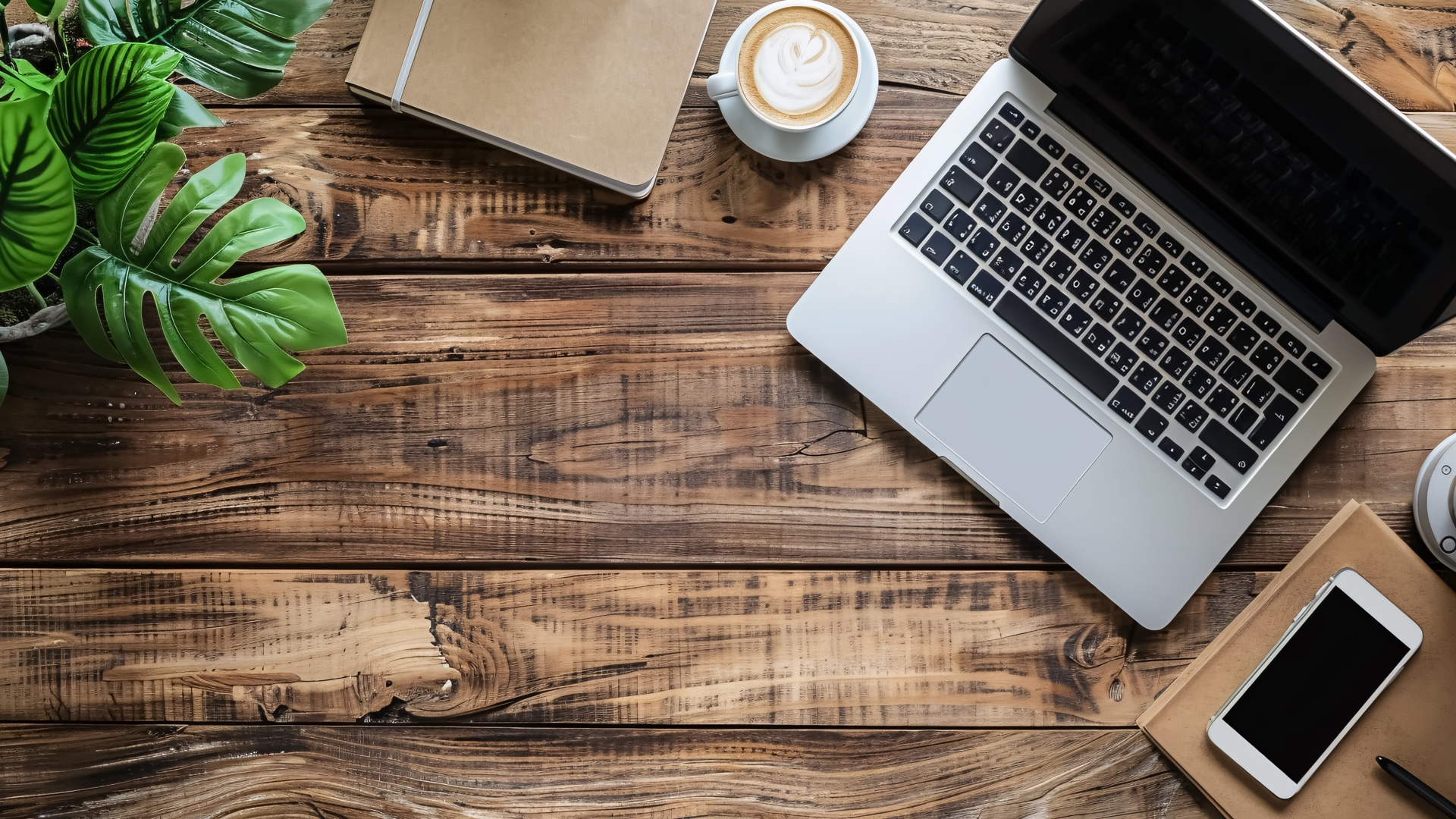 Workplace - Computer and Phone: Computer laptop and mobile phone on a wooden office desk 